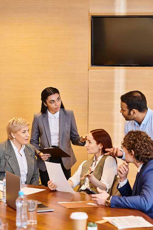 Diverse group of professionals discussing strategy and teamwork in a meeting.