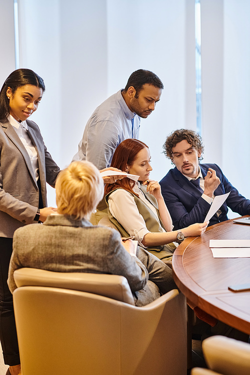 Multicultural business professionals brainstorming around a conference table.