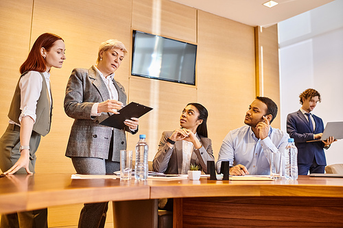 Diverse group of business professionals collaborating around a conference table.