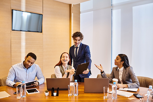 An interracial group of business people collaborating around a conference table.