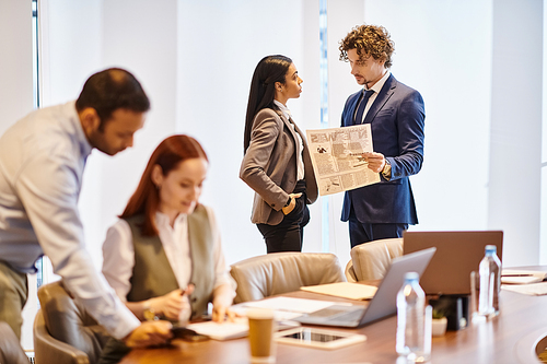 Multiracial business professionals collaborating around conference table.