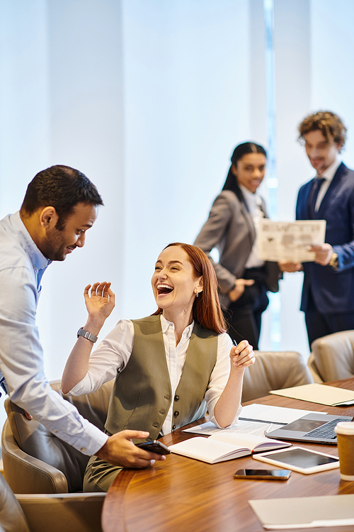 Multicultural professionals collaborate at a conference table.