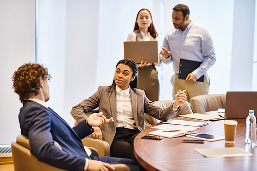 Multicultural group of professionals brainstorming around a conference table.