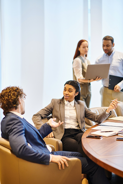 A diverse group of business professionals discussing at a conference table.