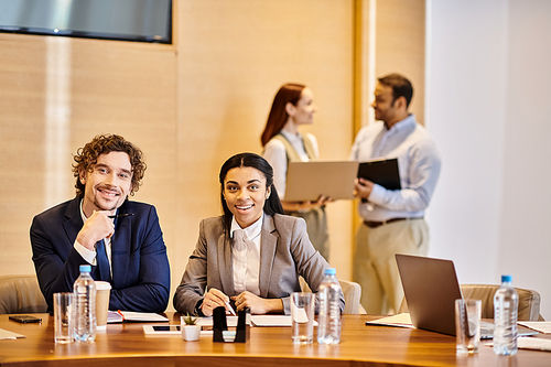 Multicultural business professionals sharing ideas around a conference table.