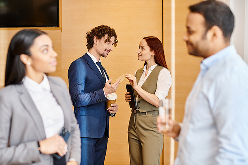 Multicultural business professionals engage in discussion and collaboration.