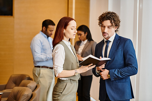 A man and woman collaborate in a vibrant conference room.