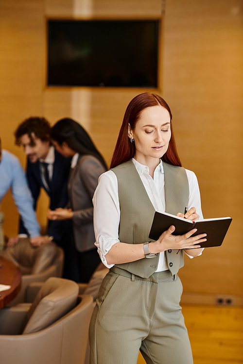 A professional woman holding a folder in a modern lobby.