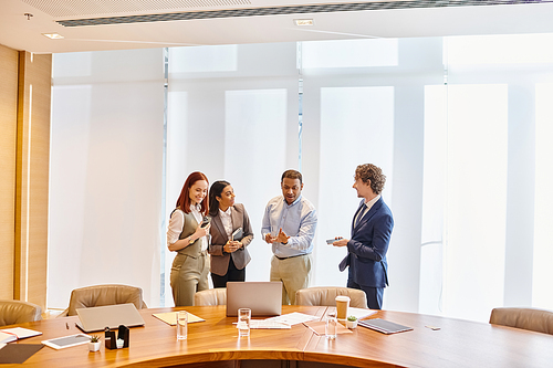 Multicultural professionals discussing at a conference table.