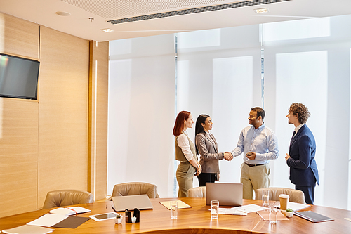 Multicultural professionals brainstorming ideas around conference table.