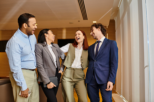 Diverse group of business professionals standing in a circle talking and collaborating.