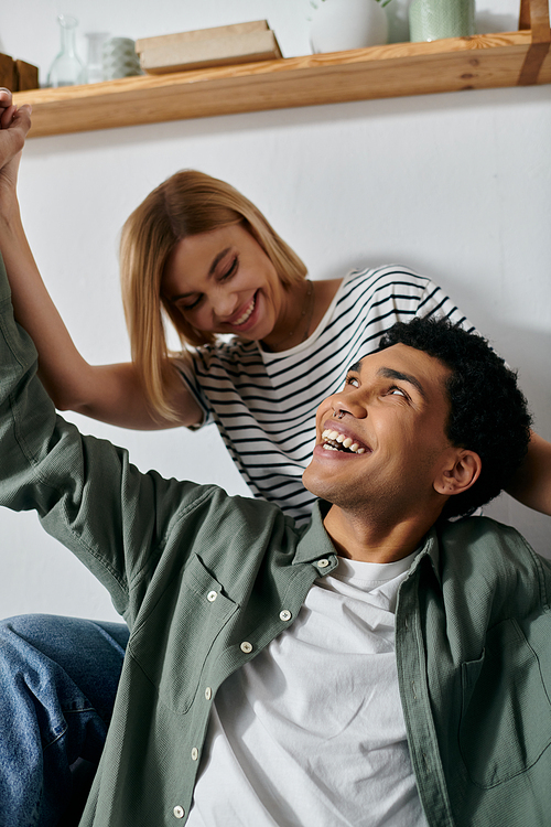 A young couple enjoys a moment of laughter and connection in their modern apartment.