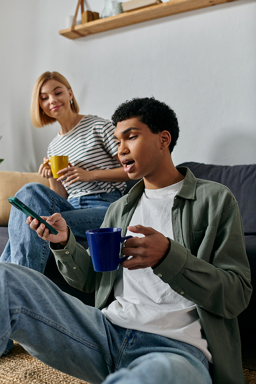 A young multicultural couple enjoys a casual afternoon in their modern apartment.