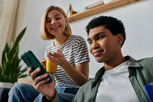 A young couple relaxes in their modern apartment, enjoying a moment of shared technology.