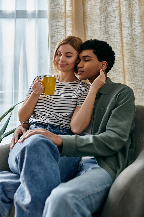 A young interracial couple relaxes in their modern apartment, enjoying a cozy afternoon together.