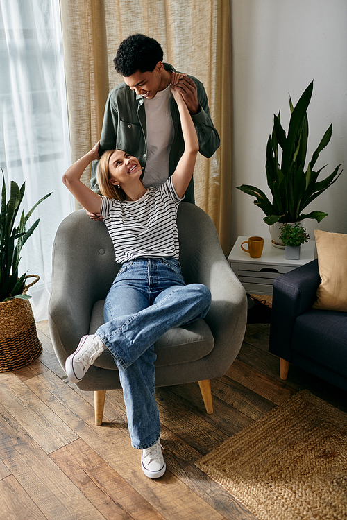 A young multicultural couple enjoys a relaxing afternoon in their modern apartment.