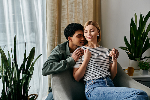 A young multicultural couple enjoys a cozy moment together in their modern apartment.