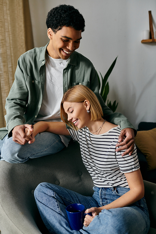 A young, multicultural couple share a tender moment in their stylish apartment.