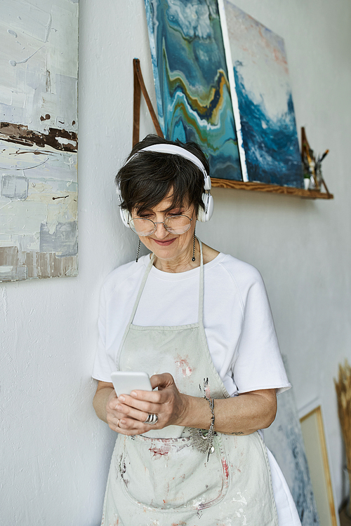 A passionate painter listens to music in her inviting art studio.