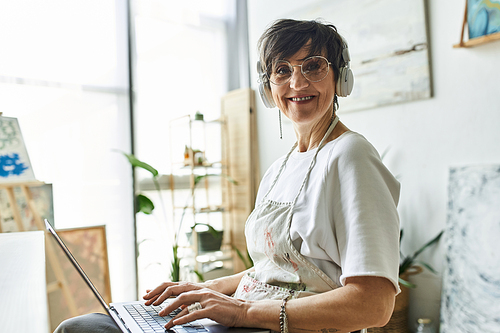 A woman enjoys her creative time in a bright, inspiring art studio.