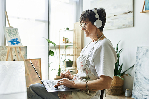 A woman engaged in digital creativity in her cozy art studio.