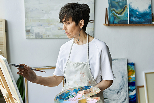 A passionate artist creates a vibrant masterpiece in her studio.