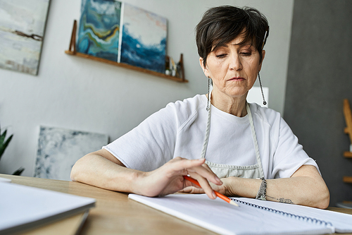 A dedicated painter thoughtfully sketching in her peaceful art studio.