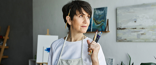 An artist contemplates her next creation in a colorful studio.