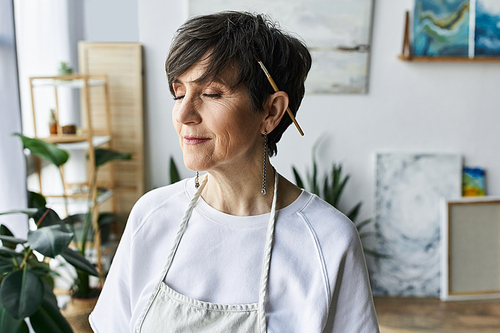 Woman enjoys a quiet moment of reflection in her colorful art studio.