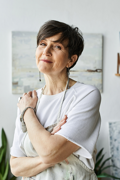 A thoughtful artist enjoys her time in a colorful studio filled with inspiration.