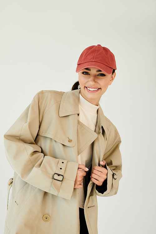 A young woman poses confidently in a fashionable autumn outfit, exuding warmth and style in the studio.