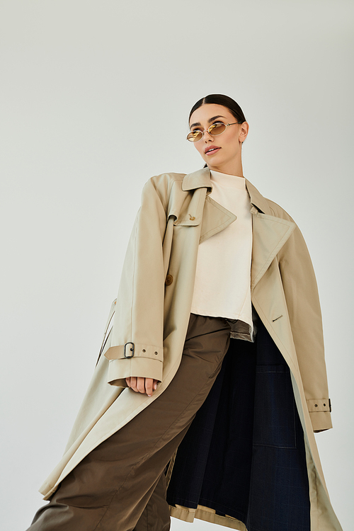 A young woman captivates with her stylish autumn outfit, radiating charm and elegance in a contemporary studio.