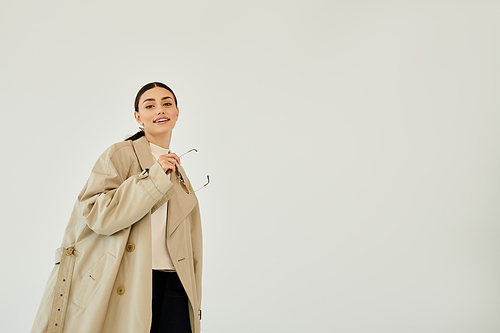 A young woman poses confidently in a chic autumn outfit, highlighting seasonal trends and elegance.