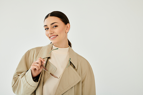 A young woman models a chic autumn outfit, exuding warmth and elegance in a serene studio ambiance, radiating style.