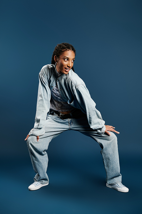 A young woman showcases her unique style and playful spirit in trendy denim attire.