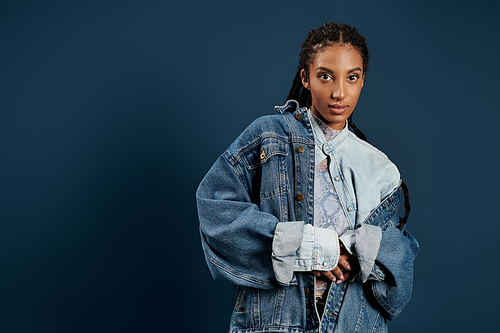 A young woman showcases her fashion sense with a chic oversized denim jacket and stylish flair.