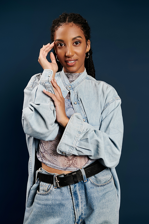 A beautiful young woman showcases her trendy outfit with confidence, expressing her unique style.