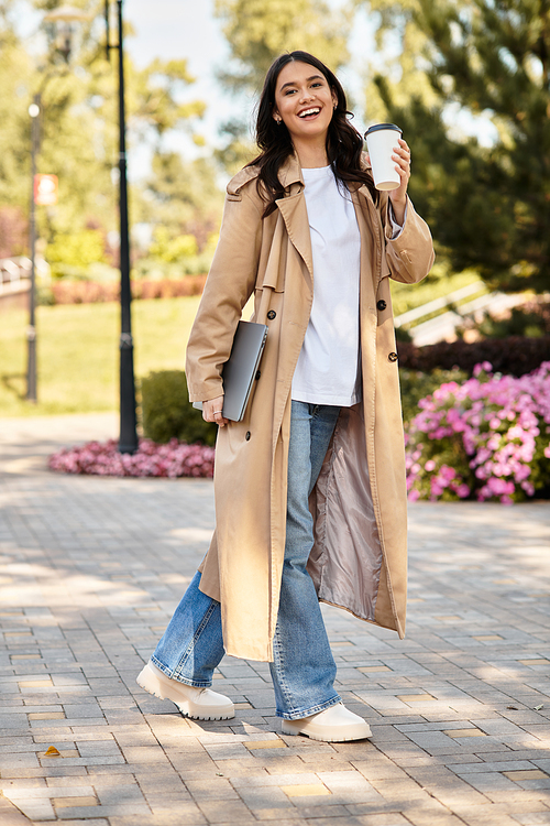 Wrapped in cozy attire, the woman strolls through a picturesque park, sipping a warm beverage.