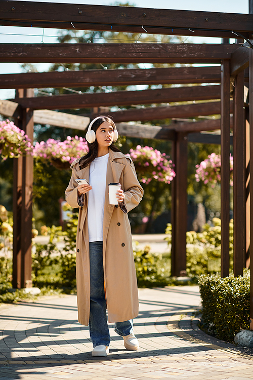 Walking through a picturesque park, a young woman embraces the beauty of autumn in style.