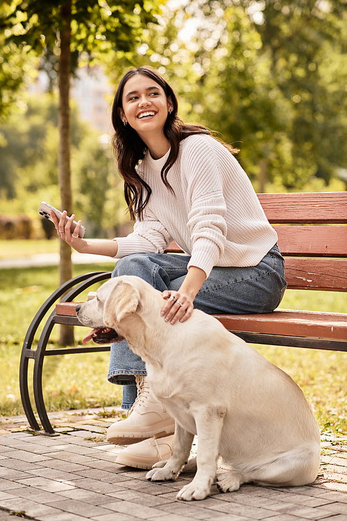 A young woman in cozy autumn attire relaxes on a bench, smiling as she pets her dog.