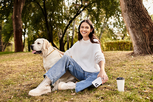 Embracing autumns beauty, a youthful woman relaxes in the park with her dog, savoring each moment.