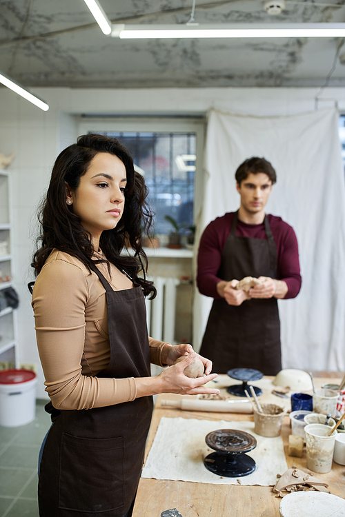 A couple enjoys crafting pottery in a stylish studio filled with creativity.