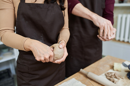 A couple enjoys crafting unique pottery in a bright, modern studio.