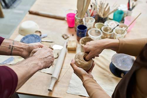 A couple shares creativity and joy while making pottery.