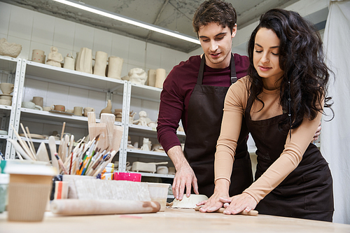 A couple crafts pottery with joy and creativity in their studio.