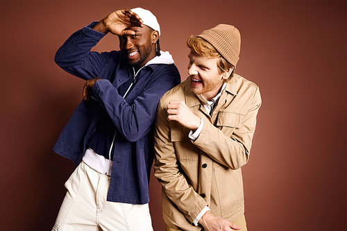 Two stylish multicultural men posing confidently together.