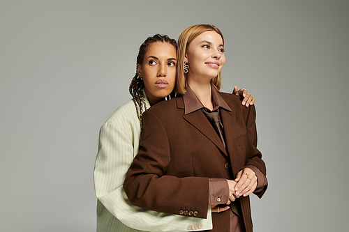 A young couple enjoys a warm moment, wrapped in fall layers, radiating love and joy.