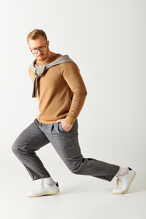 A stylish man in glasses and a sweater runs energetically.