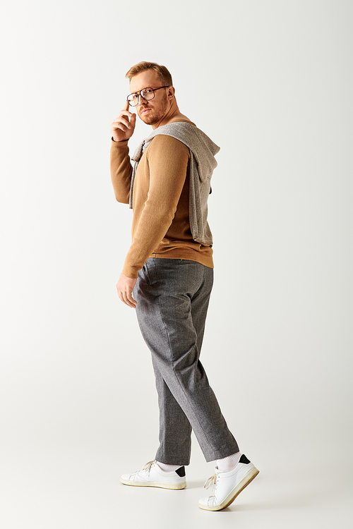 Stylish man walking, white backdrop.