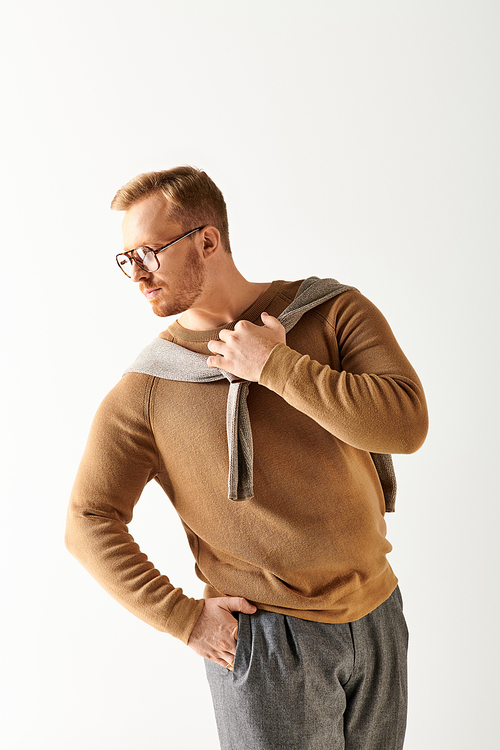 Handsome man in glasses and sweater striking a pose.